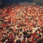 Blueberry BBQ sauce recipe simmering in pot showing whole blueberries