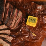 Hot and fast brisket sliced on butcher paper with Combustion Predictive Thermometer.