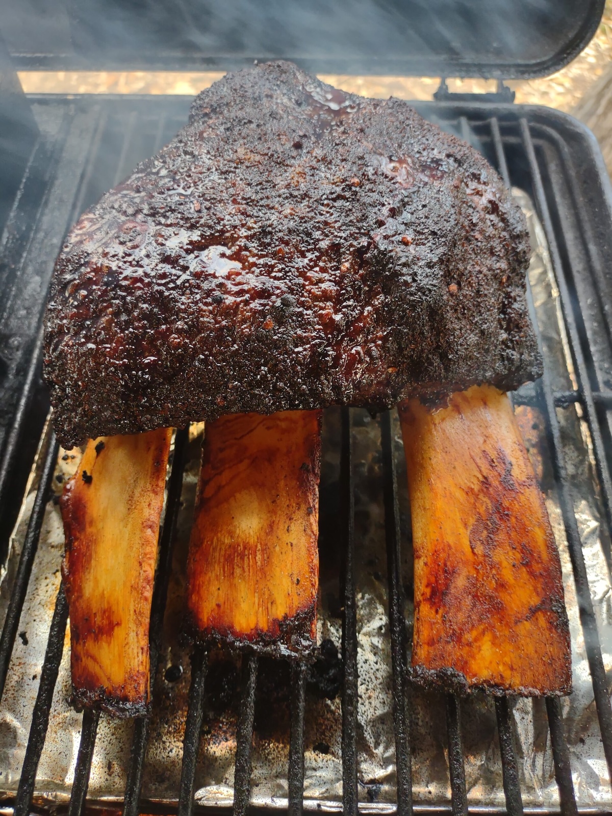 Texas beef short ribs on a smoker.
