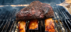 Texas beef short ribs on a smoker.