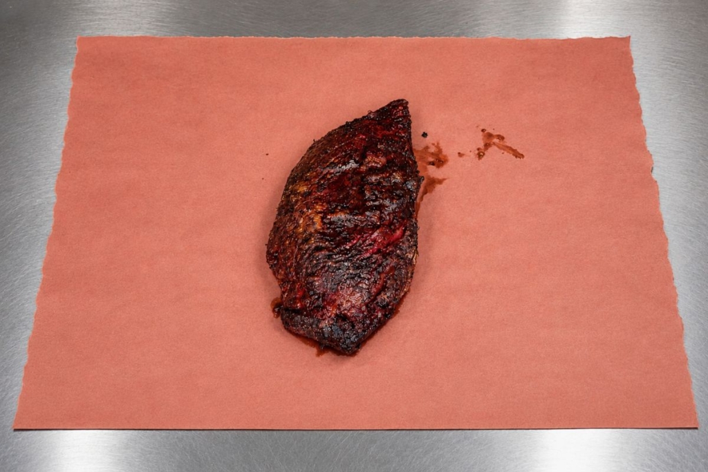 brisket on butcher paper ready to be wrapped.