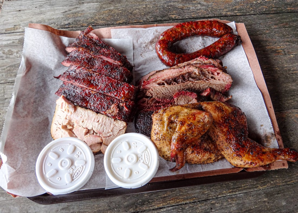 Platter of ribs, brisket, sausage, and chicken at Snow's BBQ in Lexington, Texas.